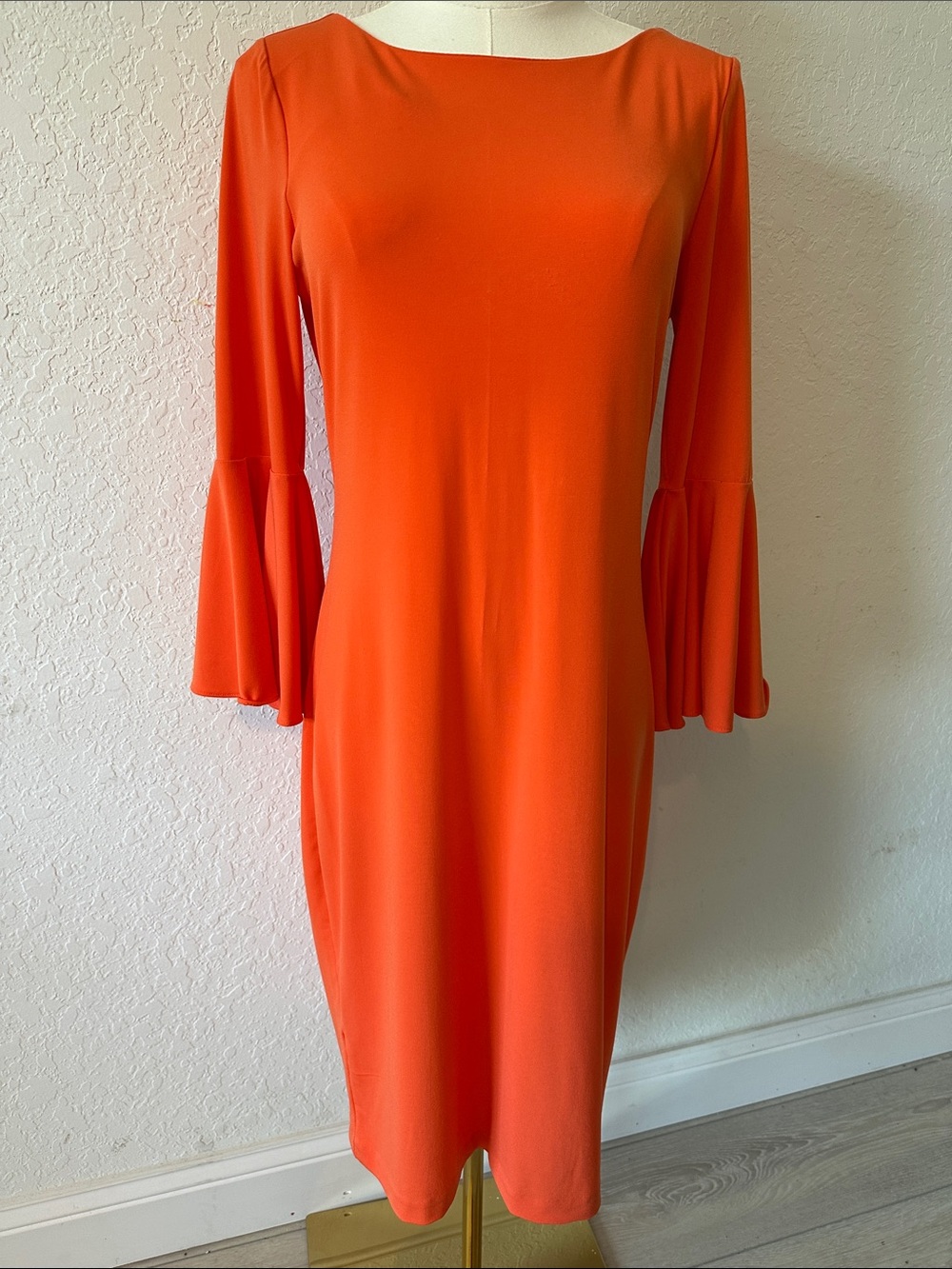 This is a bright orange Calvin Klein shift with distinctive bell sleeves size 6